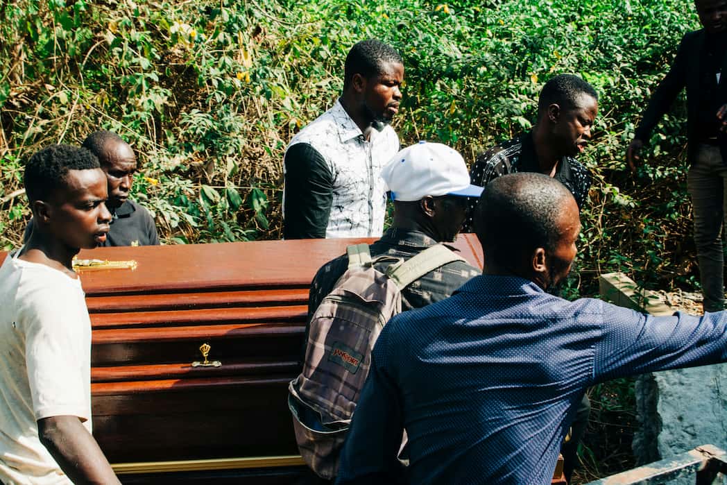 Helpful men carrying the body of the deceased during a memorial service